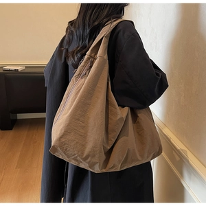Deep coffee large capacity tote bag shown from back view on model shoulder