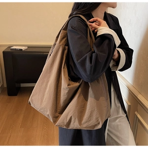 Detail of khaki slouchy tote bag showing the soft fabric texture and casual shoulder style