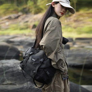 Detail view of large capacity messenger bag with durable nylon material and buckle closure