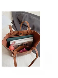 Detailed internal view of brown tote bag showing spacious storage for daily essentials