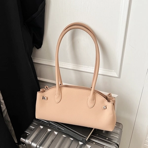 Detailed macro view of the beige lychee pattern leather and silver metal buckle on bag