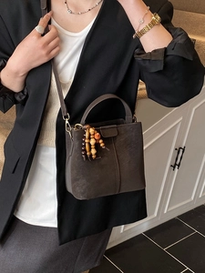 Vintage dark brown matte bucket bag with top handle and colorful ethnic bead charm