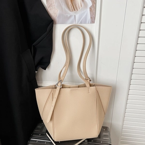 Detail of apricot faux leather tote bag with geometric stitching and triangle metal buckle