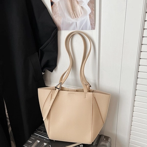 Close-up of beige lychee texture tote bag featuring a geometric design and metal buckle