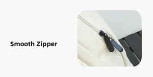 Detail of smooth black metal zippers on a premium cream soft leather waterproof backpack