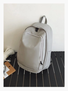 Detail shot of the light grey waterproof backpack with front double zipper pockets