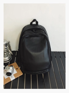 Detail shot of black minimalist waterproof leather backpack with large front pocket