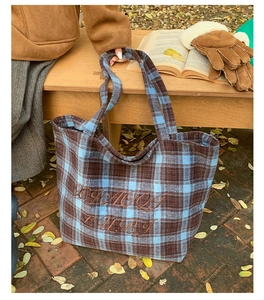 Detail of vintage plaid tote bag with intricate embroidery on thick autumn felt fabric