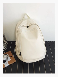 Minimalist beige waterproof leather backpack with large main compartment and front pocket