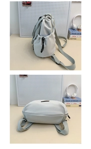 Detail view of the drawstring closure and adjustable strap on the nylon tote bag