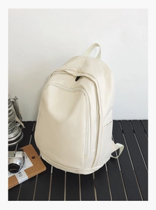 Close-up of minimalist cream waterproof backpack with large storage and hidden zipper
