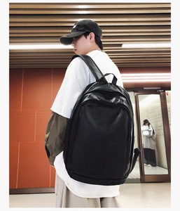 Close-up of black waterproof PU leather backpack with wide adjustable shoulder straps