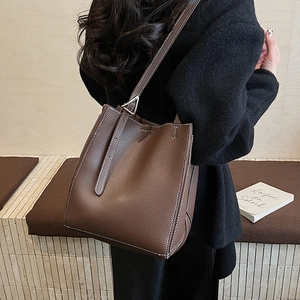 Minimalist dark coffee tote bag with white stitching and silver triangular hardware