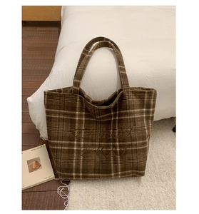 Detailed view of dark brown plaid wool tote bag with soft texture and refined embroidery