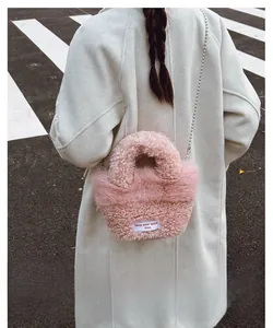 Pink plush bucket bag with chain strap and keep your spirit free woven label