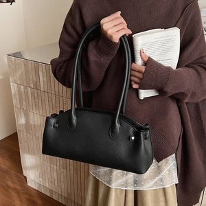 Detail of black lychee grain leather shoulder bag with silver studs and large capacity