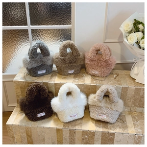 Detail showing variety of plush lamb wool mini handbags in six pastel autumn colors