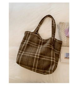 Brown vintage plaid tote bag with shoulder straps displayed in a winter lifestyle setting