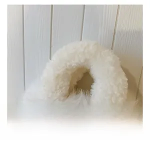 Close-up of the plush white faux fur handbag handle showing soft texture and cozy material