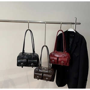 Detail of vintage Boston bags in black, dark coffee and red with silver buckle pockets
