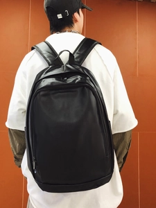 Waterproof black leather laptop backpack for men featuring large capacity and minimalist design