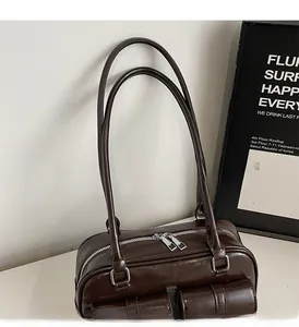 Detail of dark brown vintage Boston bag showing dual pockets and silver hardware
