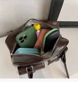 Macro view of vintage brown leather bag interior showing large capacity for daily items