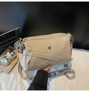 Detail of beige nylon crossbody bag with multi-zipper layers and wide jacquard strap