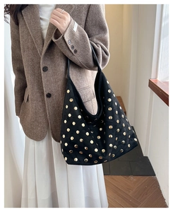 Detail of black large capacity rivet tote bag showing premium faux suede texture