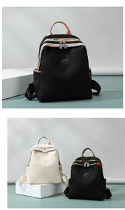 Detail view of Oxford fabric backpacks with floral patterns and logo branding