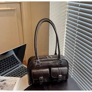 Detail of a dark brown vintage Boston bag featuring double front pockets and silver buckles