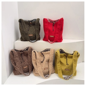 Close-up of winter wool tote bags showing textured knit fabric and wooden toggle closure