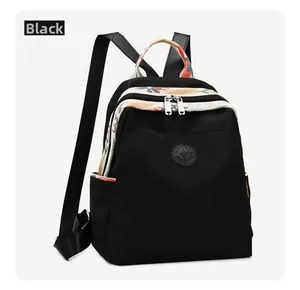 Detail view of black oxford backpack with floral straps and waterproof nylon texture