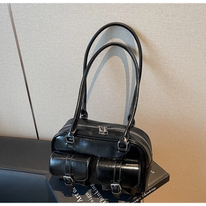 Detail of vintage black Boston bag with dual pockets and silver buckle hardware