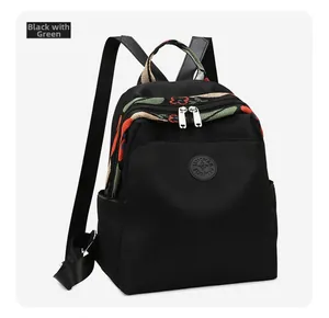 Close-up of black oxford cloth backpack featuring floral embroidery on the flap and handle