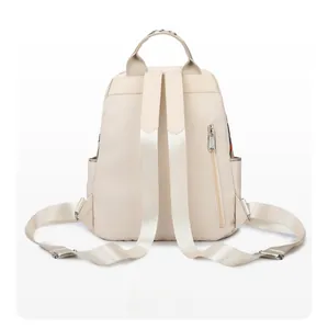 Detail view of the backpack back with wide straps and floral embroidery on handle