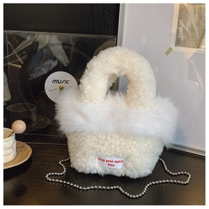 Detail of white fluffy crossbody bag with plush texture and silver metal bead chain