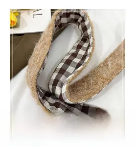 Detail of soft brown plush strap and retro plaid lining on a winter tote bag