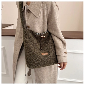 Detail of plush winter tote bag featuring faux fur texture and branded leather patch
