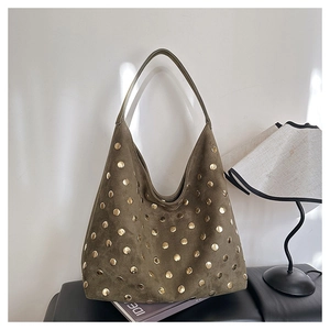 Detail of olive green suede hobo bag with gold metal studs and retro texture
