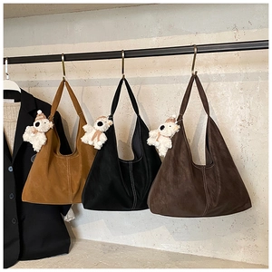 Three oversized tote bags in brown and black with cute white plush bear pendants