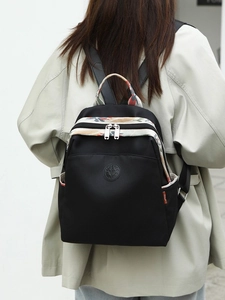 Women's black oxford backpack with floral details and large capacity for travel commuting