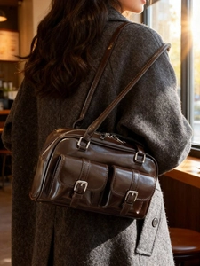 Retro dark brown oily leather Boston bag featuring front pockets and silver hardware