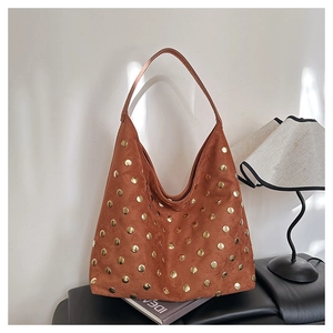 Detail of tan suede Hobo shoulder bag with gold rivets and spacious interior