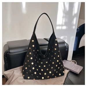 Detailed close-up of a black suede Hobo bag with gold stud rivets and shoulder strap