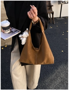Brown matte tote bag with teddy charm and contrast stitching details in autumn setting