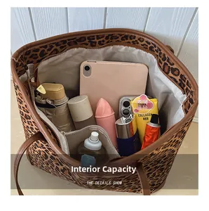 Detailed interior of leopard print tote bag showing iPad and cosmetic storage space