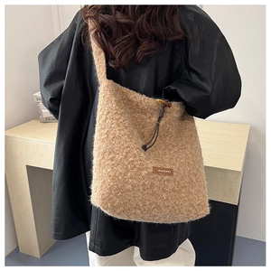 Detailed close-up of khaki plush tote bag with brown drawstring and wooden toggle detail