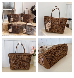 Close-up of leopard print tote bag with reinforced leather corners and plush bear charm