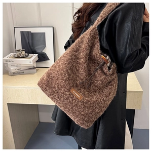 Detail of winter wool tote bag featuring plush texture, drawstring, and toggle closure